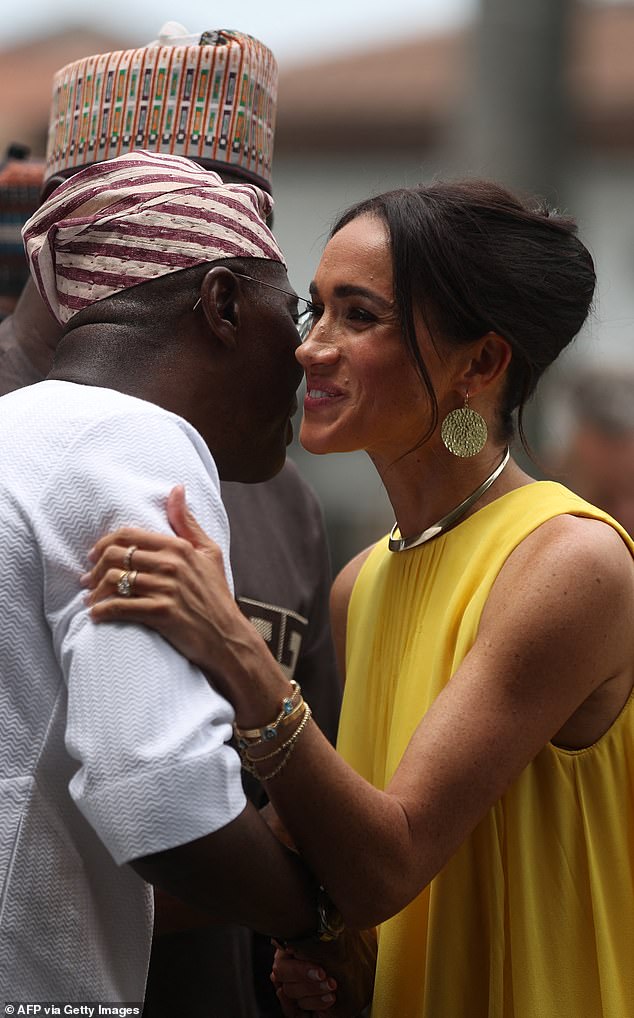 Meghan greeted the Governor of Lagos State, Babajide Sanwo-Olu (left), when he arrived at the Governor's House in the state.