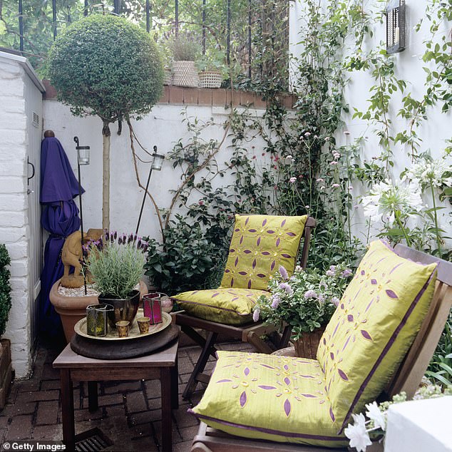 Devoting a corner of your garden to a seating area with plants cleverly arranged to enclose the space would be a more economical way to create an outdoor room.