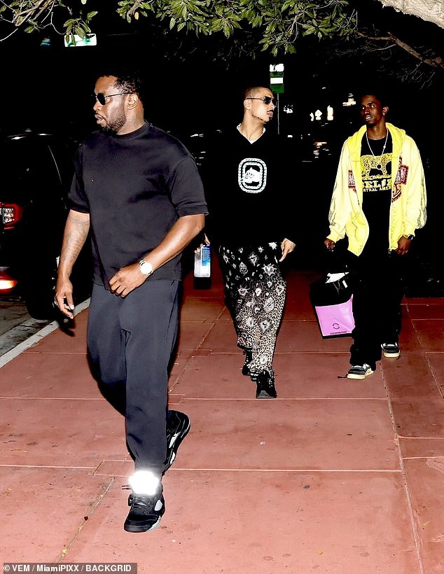 The hip-hop mogul wore an all-black ensemble when he was photographed outside the South Florida restaurant with his sons Quincy, 32, and Christian, 25.