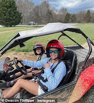 A snap shows the Sweet Home Alabama star sitting with him in a buggy