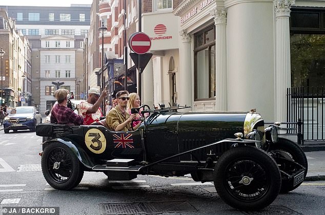 A second classic convertible followed closely behind Momoa, who also had a photographer recording videos in the back seat.