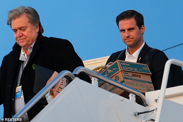 McEntee (right) arrives carrying boxes with then-White House senior adviser Steve Bannon aboard Air Force One, returning to Washington with Trump after a weekend in Florida.