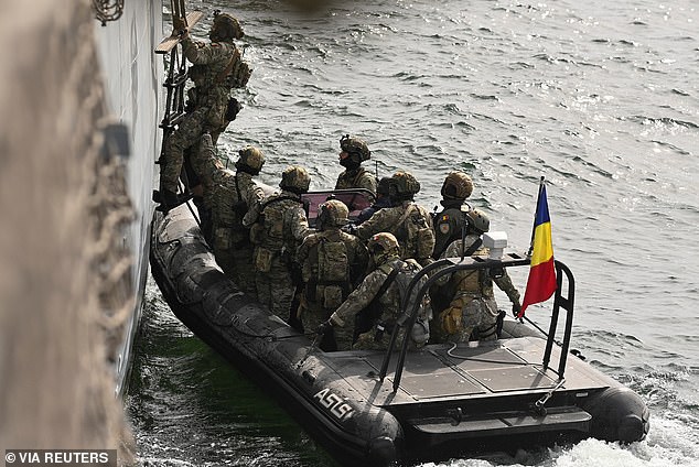 A Romanian special force boards the Romanian frigate 'King Ferdinand' during the NATO-led drill Sea Shield 2024 in the Black Sea off Constanta, Romania, April 16, 2024.