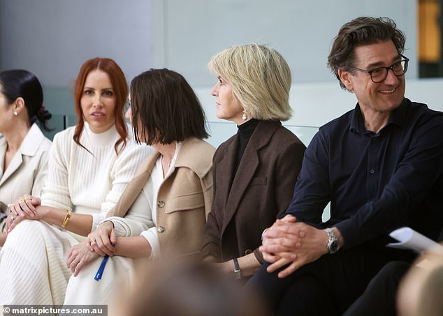 Guests seated on either side of the former foreign minister appeared engrossed in their own conversations as she shuffled in her seat.