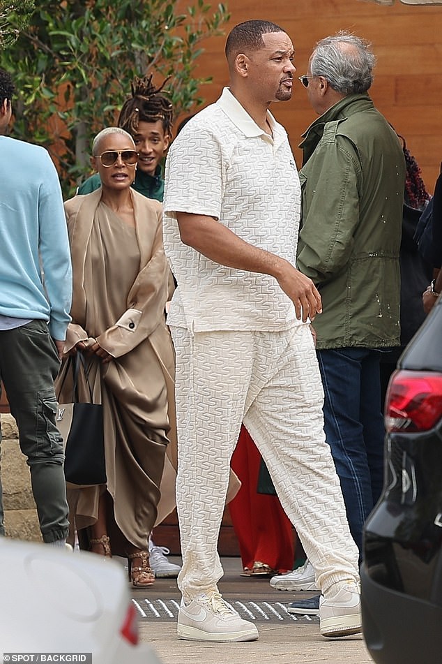 Will was seen outside Soho House wearing a tan polo shirt with wavy designs that look like writing 