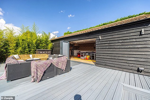 There is an outbuilding with a terrace area that can be used to entertain family and friends.