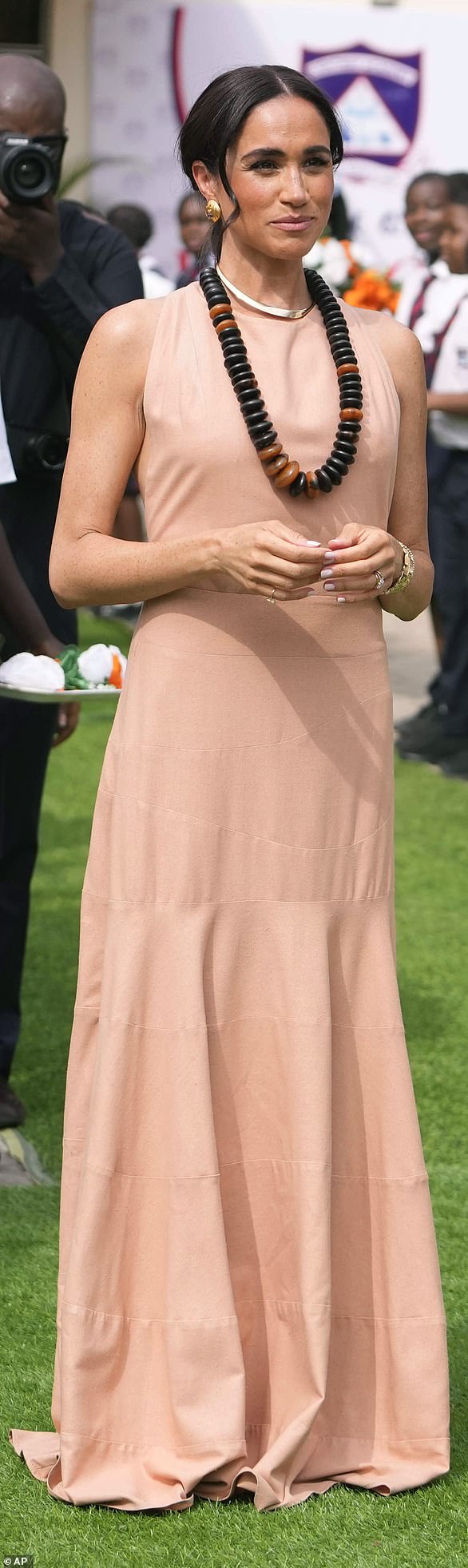 The royal mother of two kicked off the tour in a peach Heidi Merrick dress, dubbed the 'Windsor dress.'