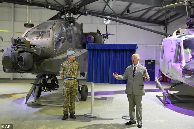 King Charles III unveils a plaque today during a visit to the Army Aviation Center in Middle Wallop