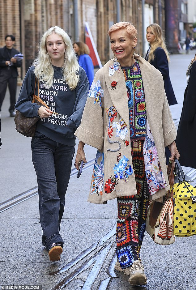 Doting mom Jessica (right) supported her daughter at the event, wearing a bright doily-inspired knit top and matching pants, underneath a beige coat covered in animal-inspired embroidery.