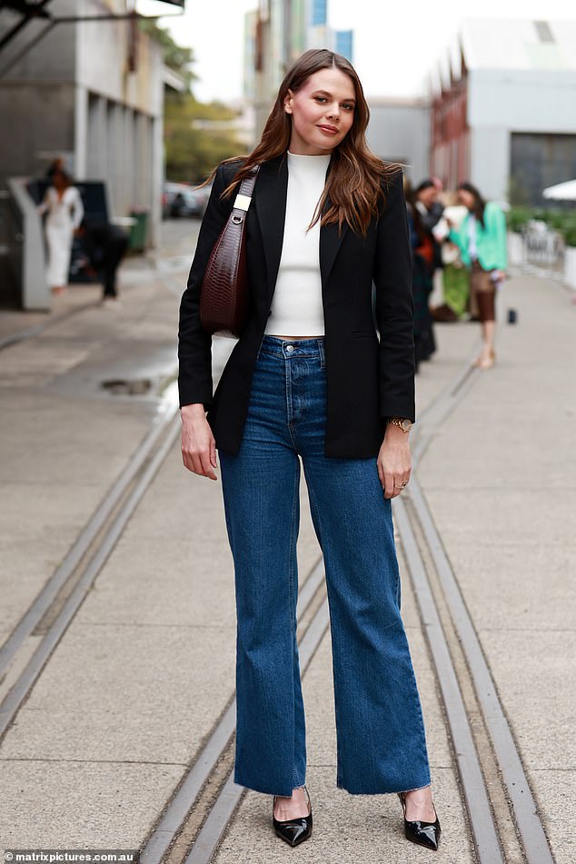 New TV presenter Lucia looked casually cool in a crisp white top under a cropped black jacket paired with flared jeans.