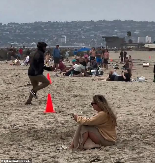 Dozens of beachgoers filmed with their phones and watched as the migrants left