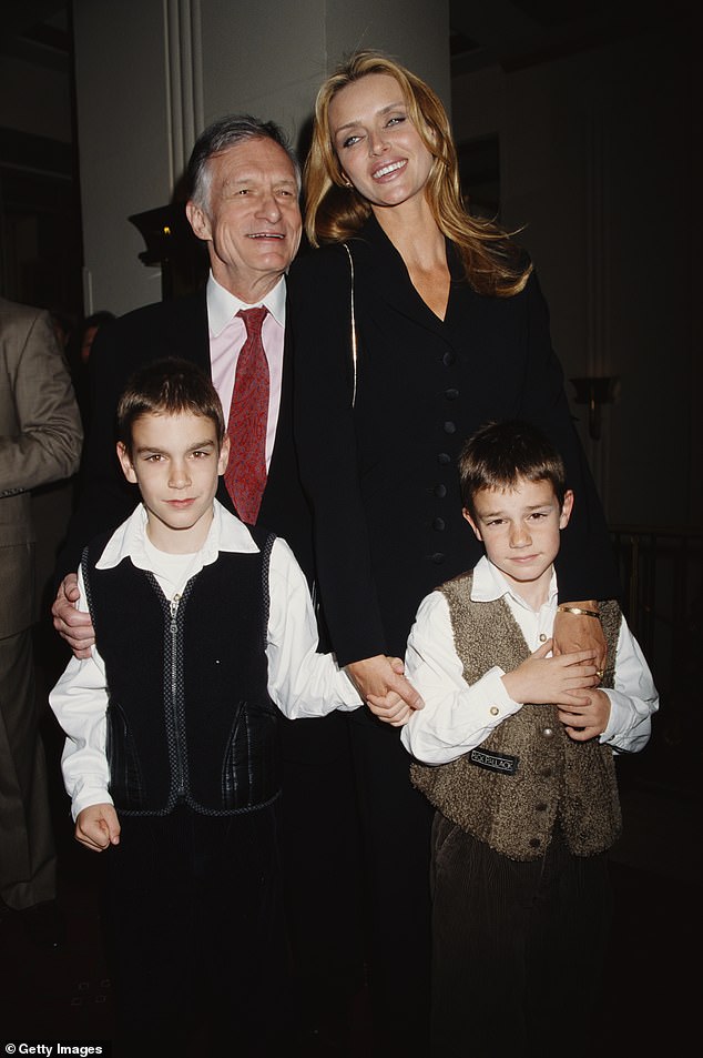 Marston and his brother Cooper, photographed with their father Hugh and mother Kimberley Conrad in 1998.