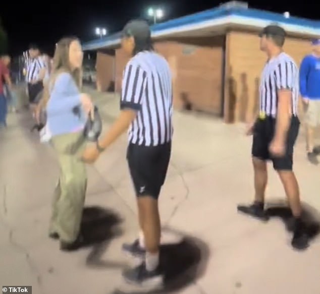 A young referee was among those who faced her fury as she tried to steer her away from the game between local rivals Cedar High and Dixie High.