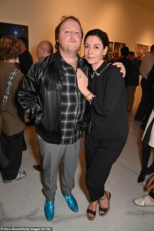 The couple smiled happily celebrating the photographer's great success.