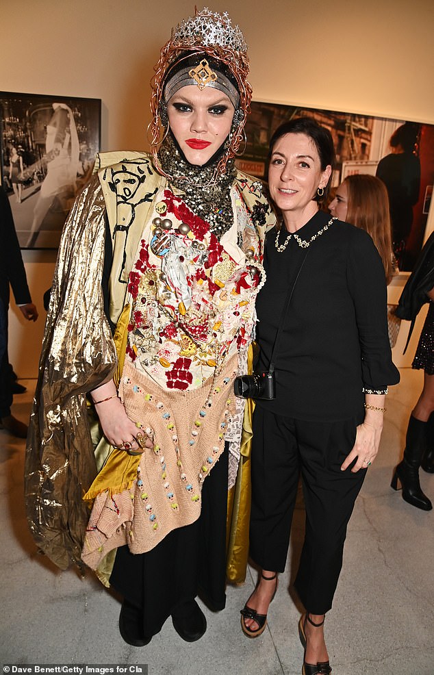 Sculptor and designer Daniel Lismore made sure to turn heads in a typically quirky ensemble made from different fabrics sewn together, complete with a turban and metal crown, as he posed with Mary.