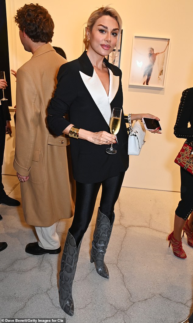 Elsewhere, designer and influencer Pegah Pourmand looked effortlessly chic in a black blazer with white details and gray snakeskin knee-high boots.