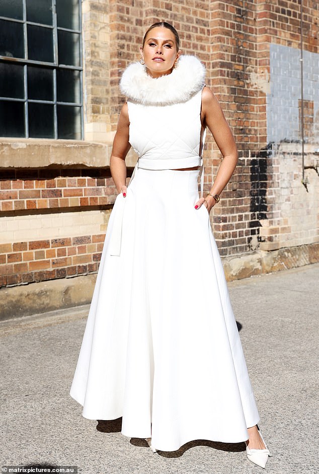 Model Natalie Roser went all out while rocking a white padded crop top with a feather neckline, paired with a dramatic skirt.