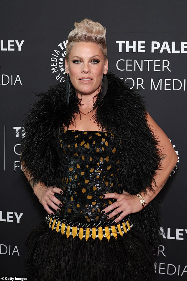 Meanwhile Pink showed off her toned legs in a black and yellow mini dress with feather trim.