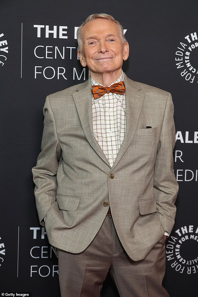 Mackie showed off his dapper style in a gray suit, striped shirt and orange bow tie.