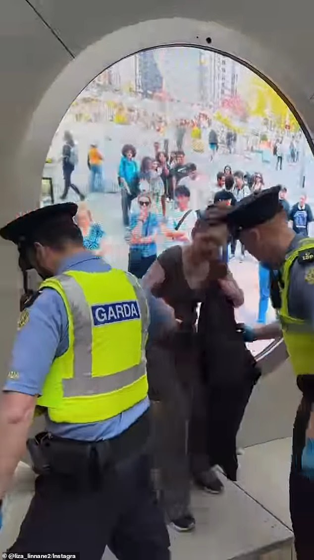 Another video showed a woman being dragged out of the portal by police after rubbing herself against the screen.