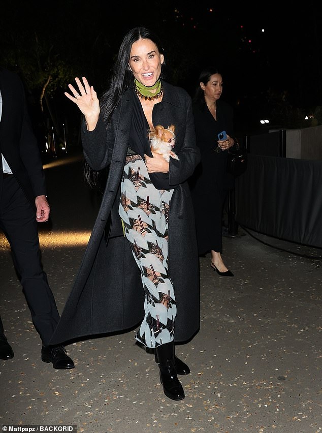 Covering her elegant dress with a long black coat, Demi greeted fans as she left the show.