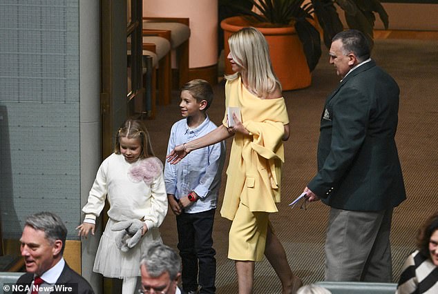 Laura Chalmers arrived at Parliament with two of her children wearing an $899 yellow Carla Zampatti dress and a $999 matching jacket.