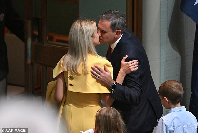 Treasurer Jim Chalmers kisses his wife Laura after delivering the 2024-25 budget