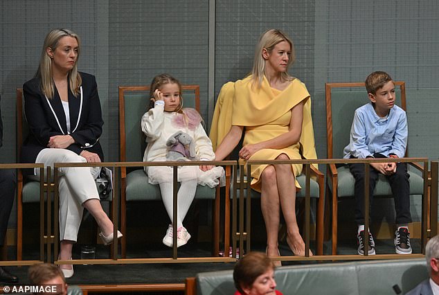 Ms Chalmers, dressed in a yellow dress to match her blonde hair, was sitting with two of her children and Prime Minister Anthony Albanese's fiancee Jodie Haydon (left) in parliament.