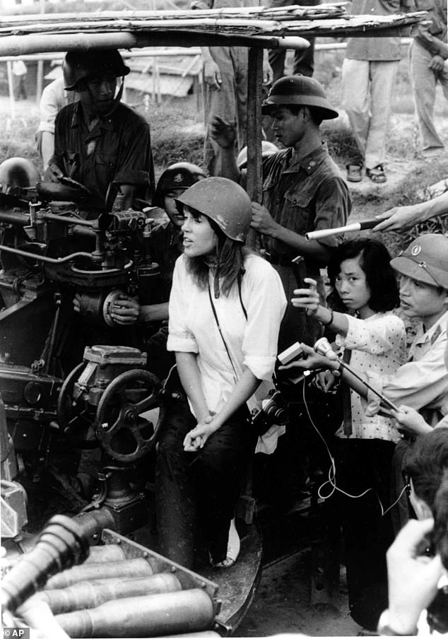 Actress Jane Fonda, seen next to a North Vietnamese anti-aircraft gun surrounded by soldiers and reporters, sings an anti-war song near Hanoi during the Vietnam War in this July 1972 file photo.