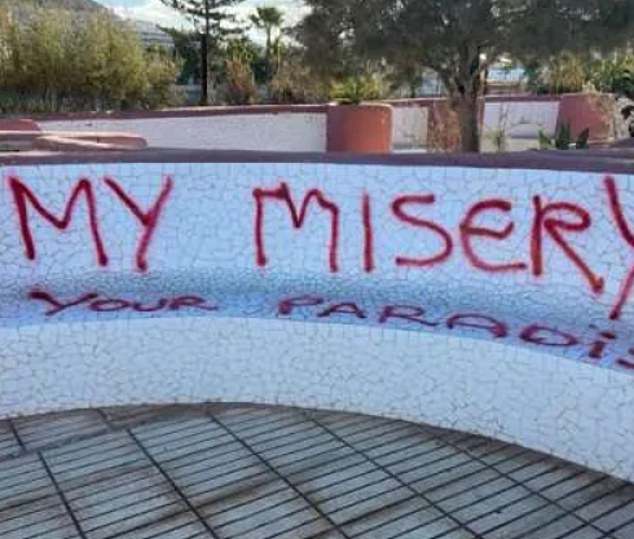 Graffiti is seen that says 'My misery, your paradise' in the Balearic Islands