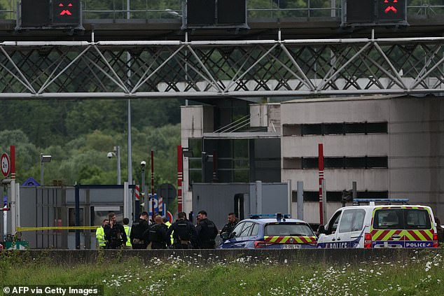 Police officers gather this morning at the site of the deadly attack in Normandy