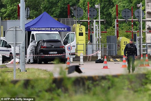 A forensic team is working at the scene of a late morning ramming attack at a tollbooth in Incarville, in the Eure region of northern France.