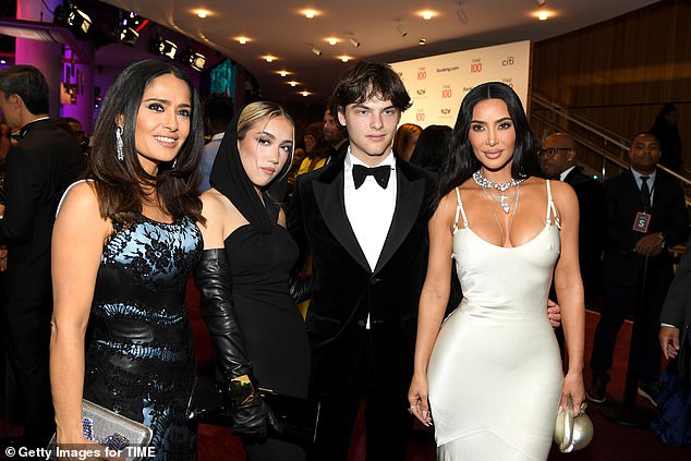 They all posed with fellow guest Kim Kardashian, far right.