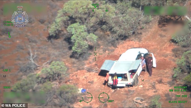 The couple got stuck in the mud (pictured) and spent three days in their vehicle trying to free her before activating an emergency beacon. The photo shows the moment they were found the next day.