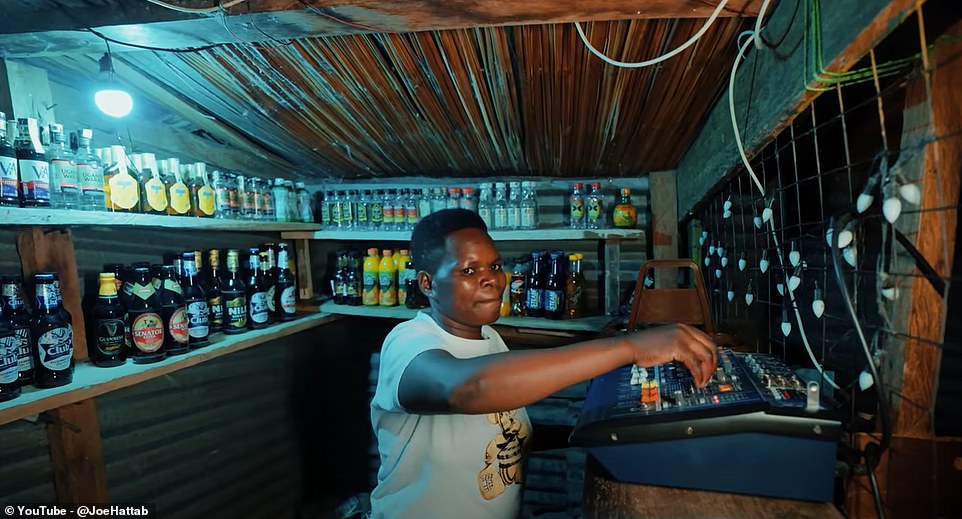 In a small supermarket where alcohol and soft drinks are sold, he finds the seller playing music and using a makeshift DJ platform.