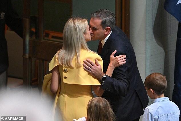 Federal Treasurer Jim Chalmers kisses his wife Laura after delivering the 2024-25 budget in Parliament