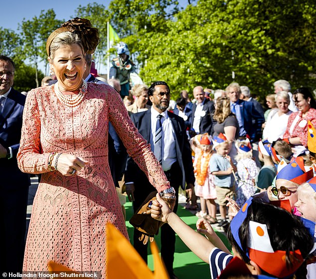 The Queen chuckled as she shook hands and spoke to the primary school children.