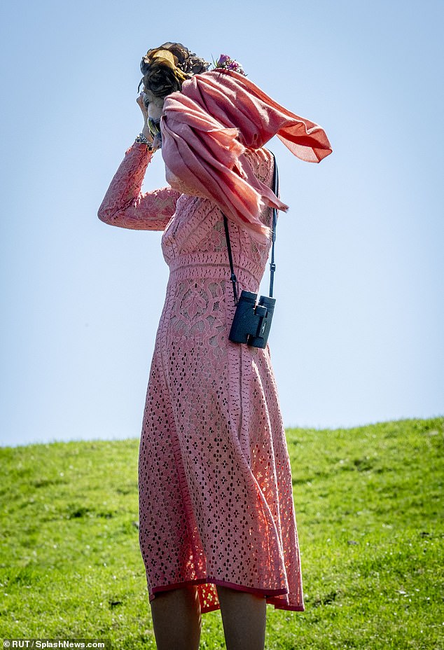 The royal had to hold on to her tiara to make sure it didn't blow away in the wind today.