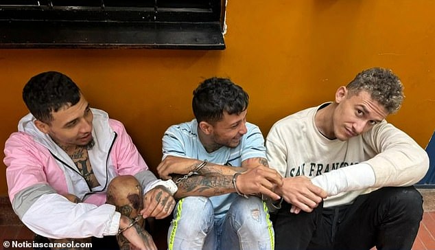 Donanfer Lunar stares at a police officer's cell phone camera while his two accomplices laugh while sitting at a local police station in Choachí, Colombia.