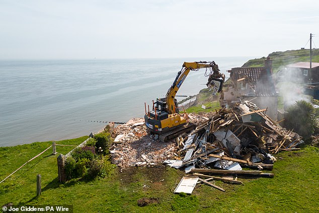 The old bricks sent clouds of dust into the air as demolition crews got to work.