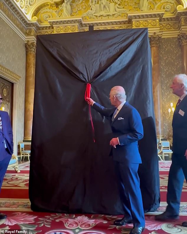 King Charles III prepares to unveil the painting at Buckingham Palace in London today.