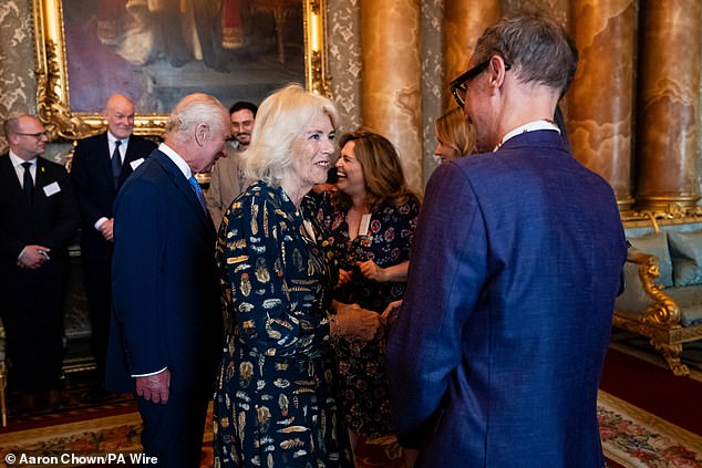 Queen Camilla is pictured warmly greeting artist Jonathan Yeo at today's opening.