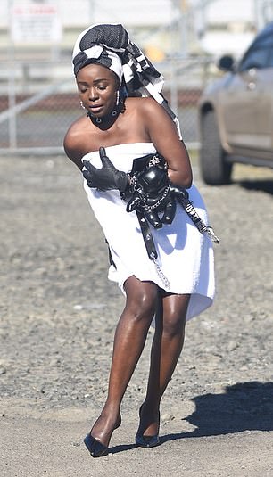 A sudden gust of wind seemed to lift the side of her dangerously short outfit.