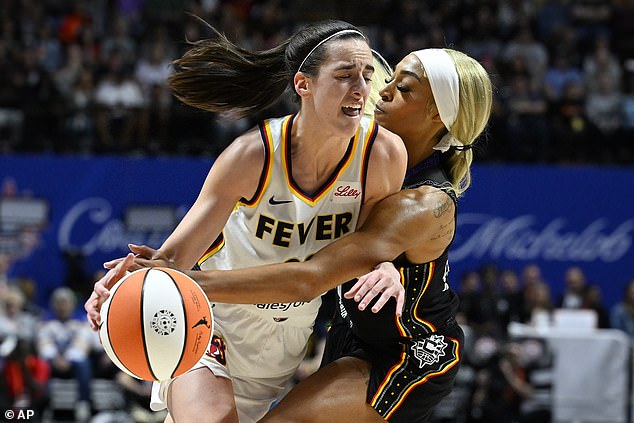 Connecticut Sun guard DiJonai Carrington (21) fouls Indiana Fever guard Caitlin Clark