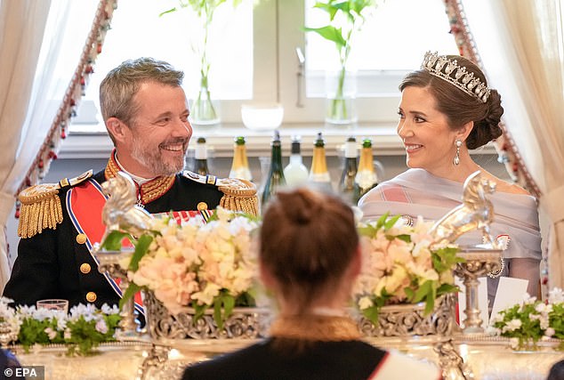 The Danish king and queen smiled and chatted as they sat next to each other at dinner, appearing completely unfazed by the affair rumors that rocked the palace in November last year.