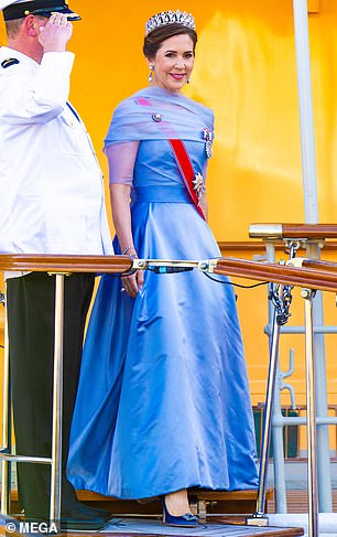 She paired the fairytale dress with a pair of blue satin pumps, as well as the priceless 200-year-old Pearl Poiré tiara worn only by the queen.