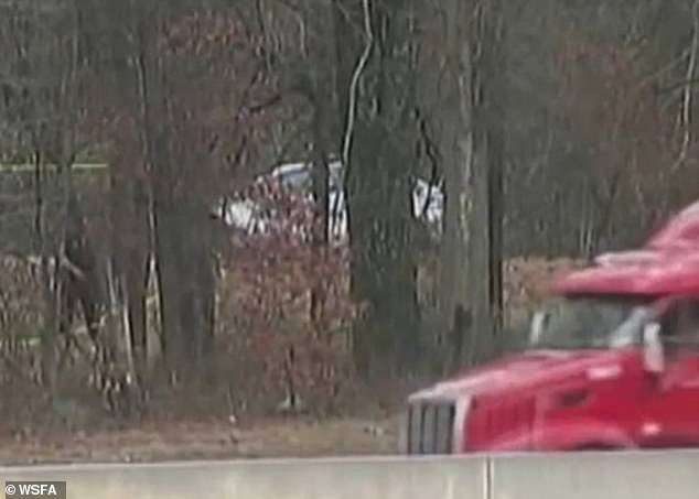 The three victims, all Montgomery residents, were found in a silver Dodge Charger near I-85 in Fulton County (crime scene pictured).