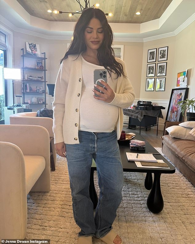 A follow-up mirror selfie revealed her pregnant belly and baggy gray-blue jeans, as well as a pair of beige sandals.