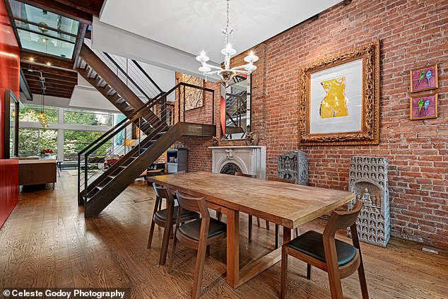 The dining room has a black walnut table that seats 10 in the middle and is surrounded by eight red Ultrasuede chairs (worth about $1,600 at time of purchase) and a hand-blown clear glass Venini chandelier ( with a price of $10,000).