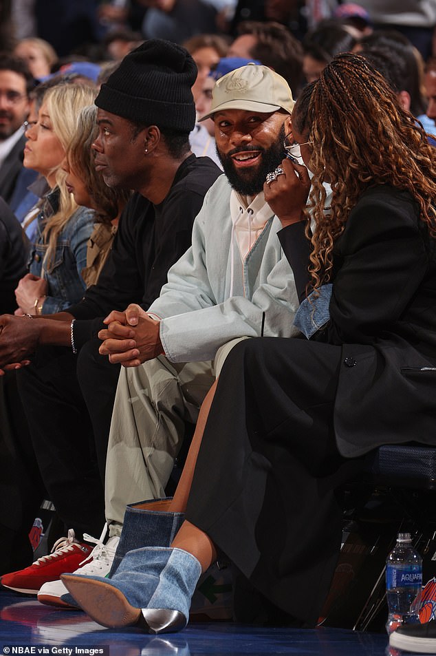 Common flashed a smile while interacting with his girlfriend Jennifer.